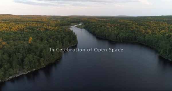aerial photograph of maine river with words overlay "in celebration of open space"