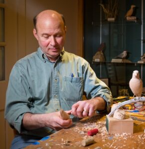 Steve Valleau doing a bird-carving out of wood