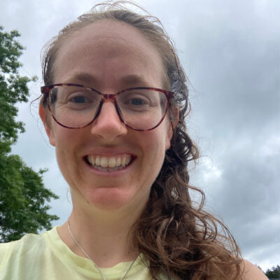 Close-up view of Caroline Moore smiling downward at the camera