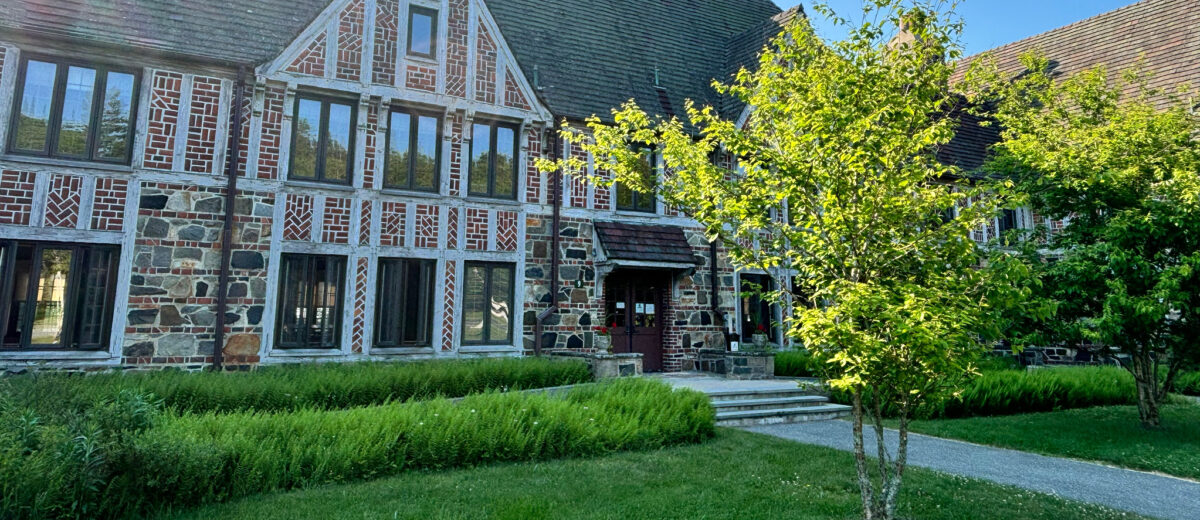 Front entrance of the Welcome Center at Rockefeller Hall on a bright, sunny day