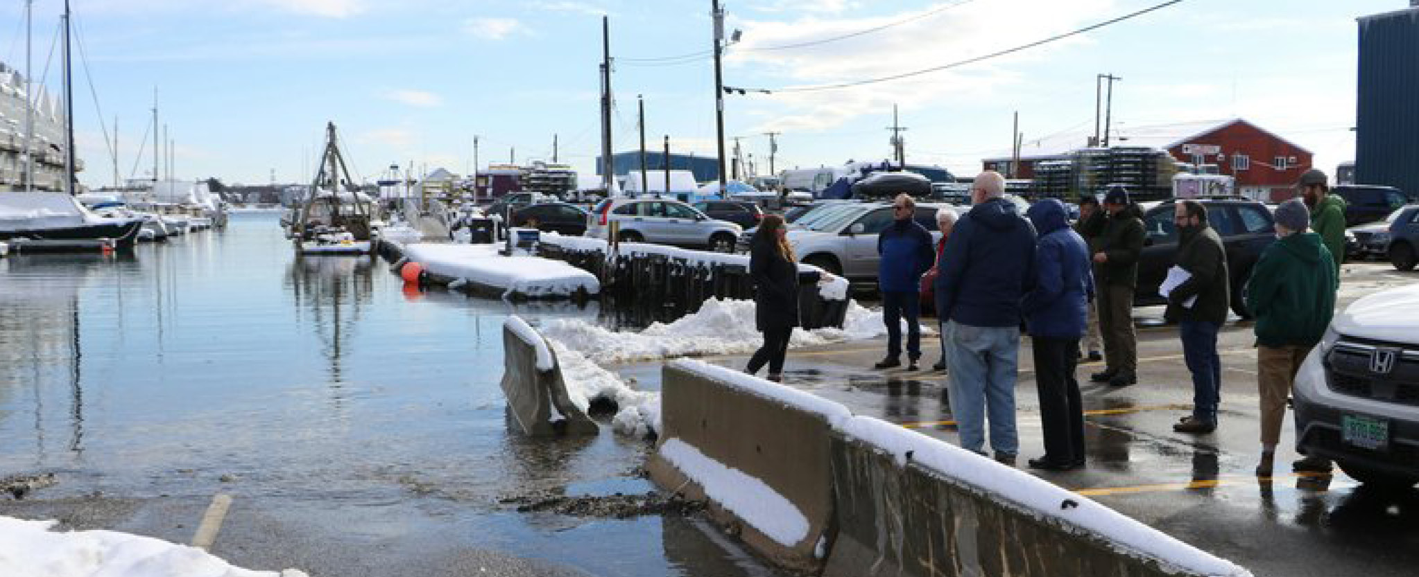 Folks gather by the docks in Portland, Maine for a community meetup on a winter day