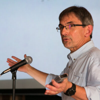 Ivan Fernandez speaks emphatically into a microphone